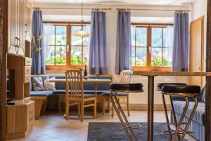 a kitchen and living room with a table and chairs at Apartments Christa App B2 in Ortisei