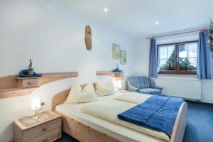 a bedroom with a bed with a blue blanket on it at Apartments Christa App B2 in Ortisei