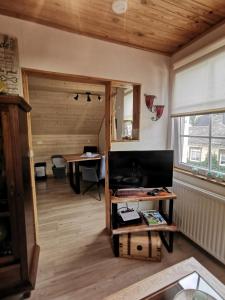 a living room with a table and a desk at Haus Sonnenschein in Bad Bertrich