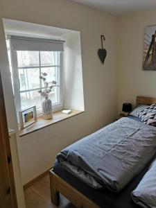 a bedroom with a bed and a window at Haus Sonnenschein in Bad Bertrich