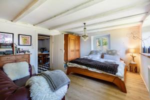 a bedroom with a bed and a couch at Ferienwohnung auf dem Wald 6 Pers in Görwihl