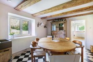 a dining room with a wooden table and chairs at Ferienwohnung auf dem Wald 6 Pers in Görwihl