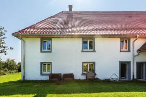a white house with a red roof at Ferienwohnung auf dem Wald 6 Pers in Görwihl