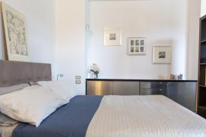 a bedroom with a large bed with a blue comforter at Studio Colline di Bardolino in Bardolino