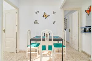 a dining room with a table and two chairs at Butterfly apartment in Nerja