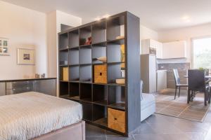 a bedroom with a large black book shelf next to a bed at Studio Colline di Bardolino in Bardolino +10 photos