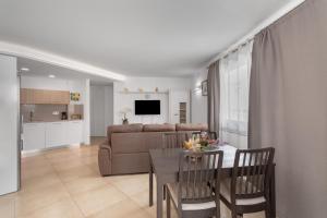 a living room with a table and a couch at Sunset Star Arguineguin in Arguineguín