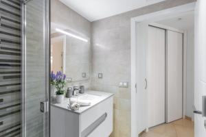 a bathroom with a white sink and a mirror at Sunset Star Arguineguin in Arguineguín +26 photos