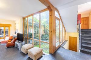 a living room with a large window and a tv at Casa Rural Cantueso 1 in La Matilla
