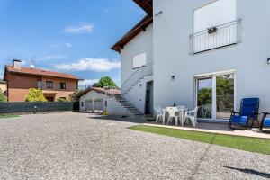 a patio of a house with a table and chairs at Villa Lilia in Arona