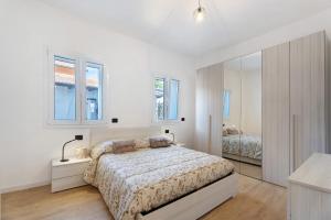a white bedroom with a bed and a mirror at Villa Lilia in Arona +44 photos
