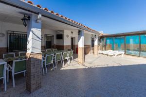 a patio of a restaurant with chairs and tables at Casa Rural Kalfonso in Mascaraque