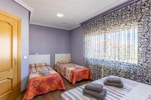 a room with two beds and a window at Casa Rural Kalfonso in Mascaraque +27 photos