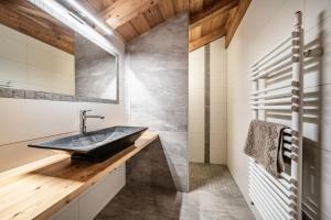 a bathroom with a sink and wood ceilings at Chalet Heidi - Chatel in Châtel +37 photos