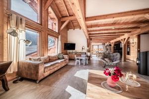 a living room with a couch and a table at Chalet Heidi - Chatel in Châtel