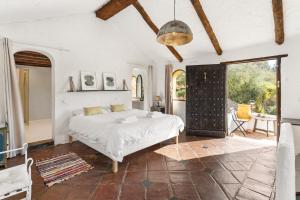 a bedroom with a white bed and a large window at Costa del Sol Retreat - 17 personas in Mijas