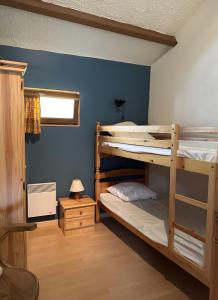 two bunk beds in a room with a blue wall at Gite Chez Lucien in Trébas +10 photos