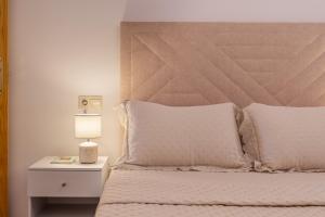 a bedroom with a bed and a night stand with a lamp at Apartamento Molinillo in Monachil