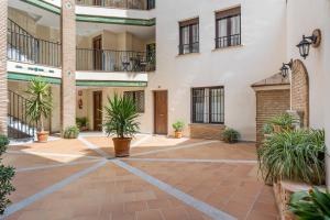 a courtyard in a building with potted plants at Apartamento Molinillo in Monachil