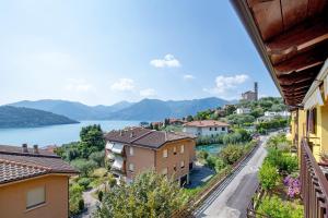 a view of a town with a lake and mountains at Miralago Marone Holiday House in Marone