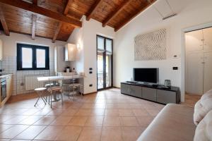 a large room with a kitchen and a living room at Miralago Marone Holiday House in Marone