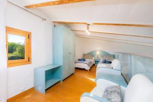 a living room with white furniture and a window at Es Collet in Manacor +22 photos