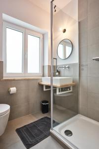 a bathroom with a shower and a sink and a toilet at Alte Seifensiederei - Malala in Bad Tölz