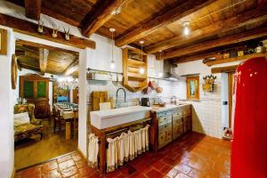 a large kitchen with a sink and a table at Le Chalet du Coq Rouge in Valtournenche +23 photos