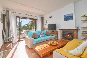 a living room with a couch and a fireplace at El Nido in Almuñécar