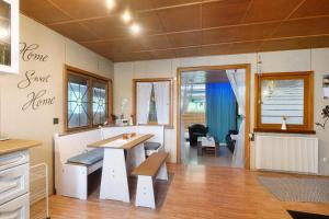a room with a table and a bench in it at Haus am See in Gedern +21 photos