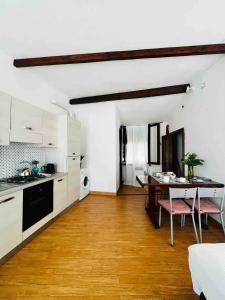 a kitchen with a table and a dining room at La Terrazza di Vernazza in Vernazza
