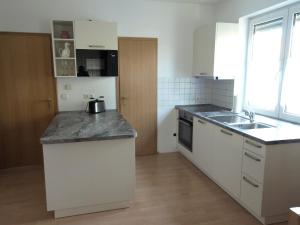 a kitchen with a sink and a counter top at Apartment Mengelberg in Markkleeberg