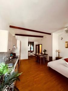 a kitchen and living room with a bed and a table at La Terrazza di Vernazza in Vernazza +21 photos