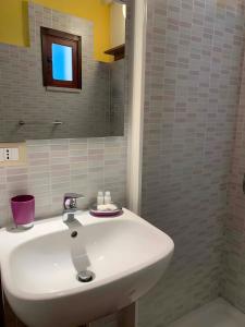 a bathroom with a white sink and a mirror at La Terrazza di Vernazza in Vernazza