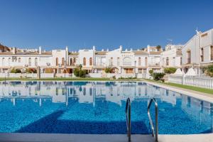 a large swimming pool in front of white buildings at 53 Luz Bahia in Mazarrón