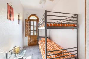a room with a bunk bed with an orange bedspread at 53 Luz Bahia in Mazarrón +17 photos