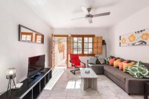a living room with a couch and a tv at 53 Luz Bahia in Mazarrón