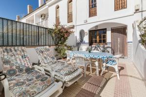 a patio with a table and chairs on a balcony at 53 Luz Bahia in Mazarrón