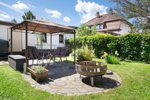 a patio with a table and a gazebo at Nette Hütte in Bad Säckingen