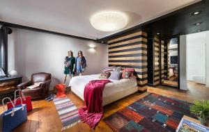 two women standing in a bedroom with a bed at וילה levi in Chorazim +26 photos