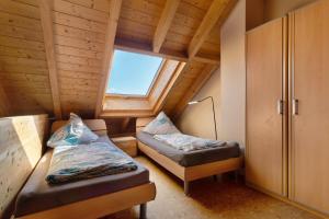 a small room with two beds and a window at Obst- Und Ferienhof Brudy in Appenweier