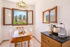 a kitchen with a table and a counter with a coffee maker at Casa Tramuntana in Sóller