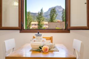 a wooden table with a plate and cups on it at Casa Tramuntana in Sóller