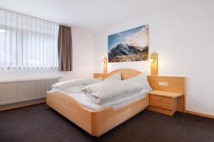 a bedroom with a large bed with white pillows at Haus Lena in Solda