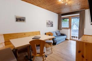 a living room with a table and a couch at Haus Lena in Solda +28 photos