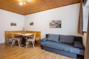 a living room with a couch and a table at Haus Lena in Solda