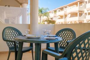a blue table with two chairs and wine glasses at Playasol in Vinarós