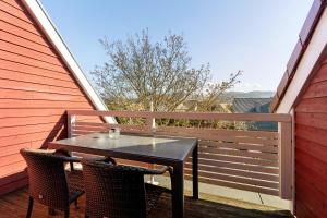 a black table and two chairs on a balcony at Obst- Und Ferienhof Brudy in Appenweier