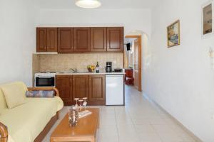 a living room with a couch and a kitchen at Studios Asterias 2 in Astypalaia +27 photos