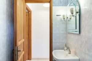 a bathroom with a sink and a mirror at Studios Asterias 2 in Astypalaia